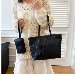 Detailed view of black houndstooth pattern tote bag set with matching small pouches
