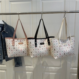 Three stylish printed tote bags with cute cartoon patterns and slim leather straps