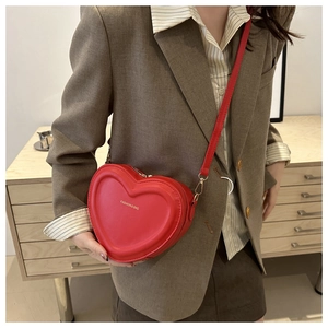Red heart-shaped crossbody bag with embossed texture and Fashion & Bag lettering on strap