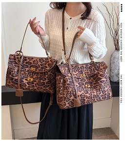 Detail of leopard print tote bags with gold metal clasps and leather straps on a model