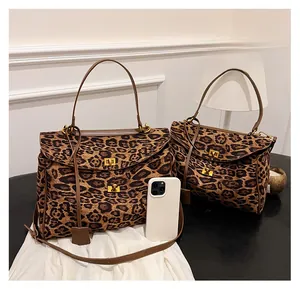 Leopard print tote bags in two sizes with gold twist locks and brown leather handles