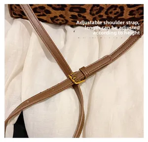 Detail of leopard print suede tote bag with adjustable brown leather shoulder strap