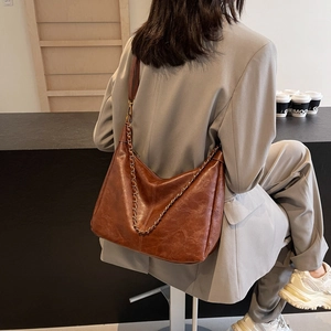 Deep brown oversized oil wax leather tote bag with stylish metal chain for women