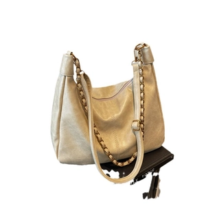 Minimalist beige PU leather hobo bag with textured pleats and gold chain strap