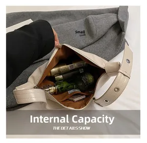 Detail view of large cream leather tote bag interior with multiple beauty products