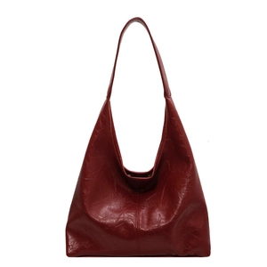 Large burgundy soft leather tote bag with wide shoulder strap and glossy finish