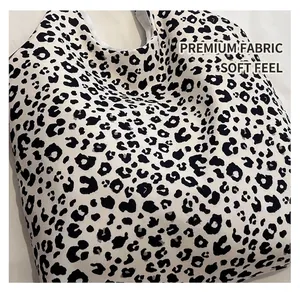 Close-up of the thick leopard print canvas fabric on this stylish black and white tote bag