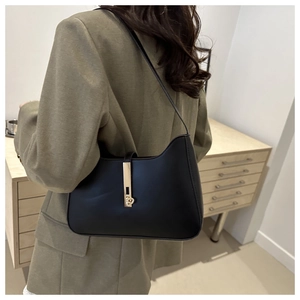 Detail of a black half-moon underarm bag with a premium gold metal buckle for daily use