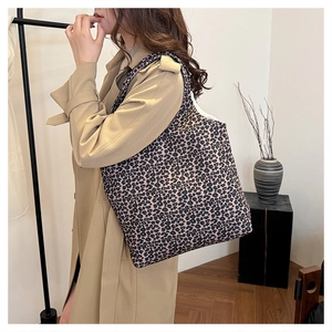 Detailed shoulder view of a large leopard print canvas tote bag for women