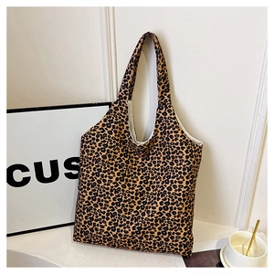 Detailed view of the leopard print canvas tote bag with long handles and white interior