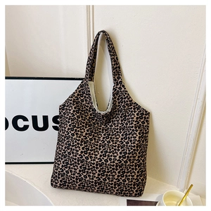Detail view of large capacity tote bag featuring classic leopard print pattern