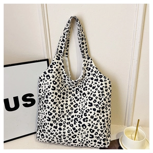 Detailed view of spacious leopard print canvas tote bag with black and white patterns