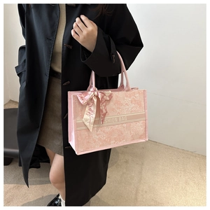 Detail of pink floral tote bag with silk scarf handle and chic printed patterns