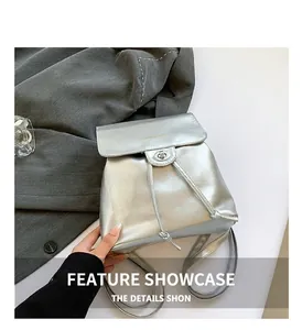 Close-up of silver PU leather bucket bag with metallic twist lock and drawstring detail
