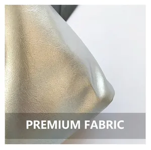 Macro shot of silver metallic textured faux leather material on woman's backpack