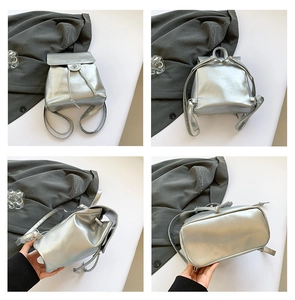 Detail view of silver PU leather mini backpack with drawstring closure and magnetic flap