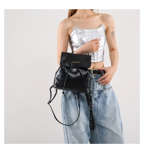 Detail of black faux leather backpack with gold buckle and Fashion & Bags text logo
