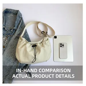 Detailed top view of off-white drawstring crossbody bag showing spacious interior capacity