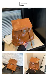 Close-up of brown PU leather backpack featuring a silver metal twist lock and drawstring