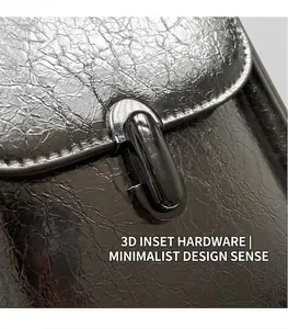 Detail of silver metallic cracked texture handbag with an industrial metal buckle closure