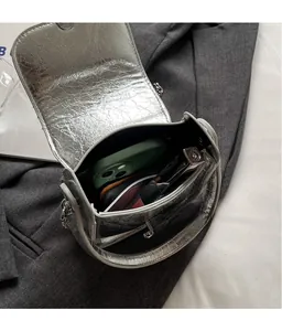 Macro view of silver metallic bag interior with chain strap showing daily item storage