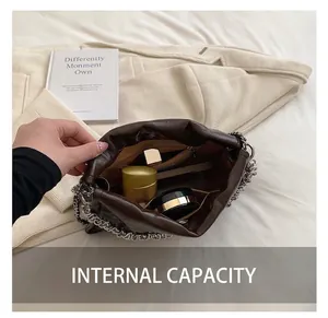 Detail of deep brown textured chain bag showing large interior capacity for daily essentials