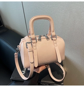 Detail of light pink Boston bag with double zippers and silver hardware finish
