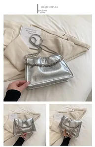 Detail of silver metallic leather handbag with wrinkled texture and chunky chain strap