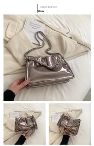 Detailed view of pewter metallic chain handbag featuring a glossy textured finish