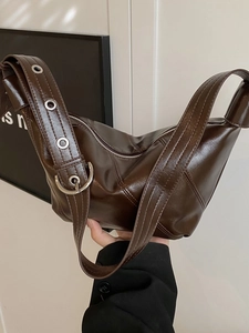 Retro dark brown slouchy hobo bag with wide grommet strap and polished PU leather finish
