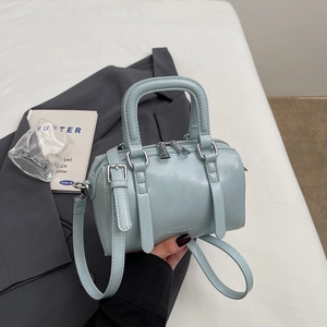 Light blue Boston pillow handbag with silver hardware and adjustable strap for women