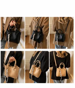 Model showcasing versatile lychee grain leather bucket bag in black and khaki colors