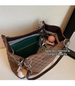 Interior view of large checkered tote bag showing capacity for laptop, umbrella, and bottle