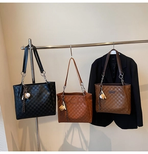 Detailed display of large capacity tote bags with plaid embossing and chain straps
