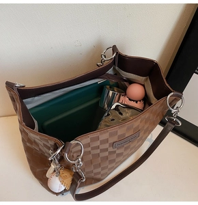 Detail view of large checkered tote bag showing spacious interior with zipper pocket