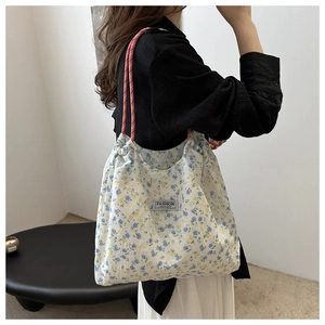 Detail of floral canvas tote with orange rope handles and Fashion Instinct patch