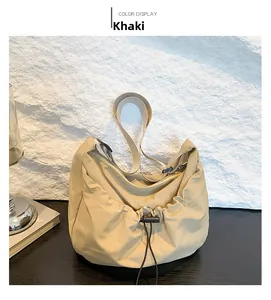 Detail view of khaki crossbody bag with drawstring design and wide nylon shoulder strap