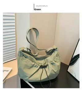 Detail view of the green pleated bag showing drawstring closure and nylon fabric texture