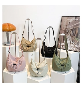 Collection of Morandi colored nylon drawstring crossbody bags on display stands