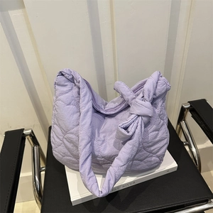 Light purple quilted tote bag with heart embroidery and large bow knot strap detail