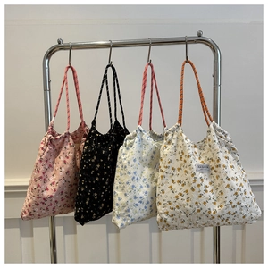 Set of four floral nylon tote bags with drawstring closure and rope shoulder straps