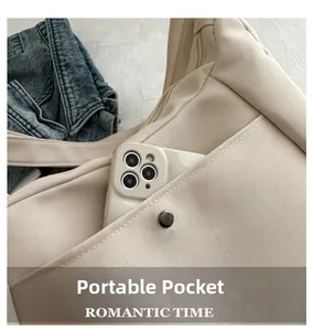 Macro detail of beige canvas bag featuring a practical side pocket with a metal snap button