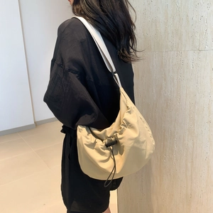 Light beige drawstring pleated crossbody bag made of nylon for casual commuting