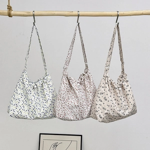 Three minimalist floral canvas shoulder bags with drawstring design in different colors