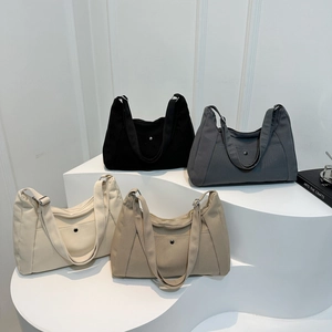 Minimalist canvas tote bag for women in four solid colors on a display stand