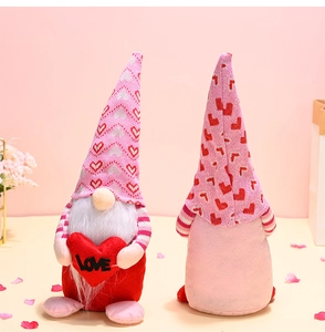 Detail of pink Valentine's gnome pair with embroidered LOVE heart and plush fabric texture