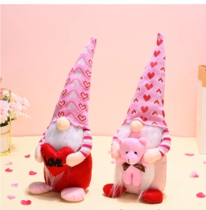 Detail of handmade Valentine gnomes with love heart and teddy bear on pink background