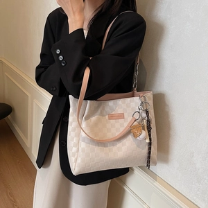 Beige checkered tote bag with pink lining and baseball charm accessory for women