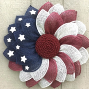 Detail of burlap sunflower wreath in American flag colors for Independence Day decoration