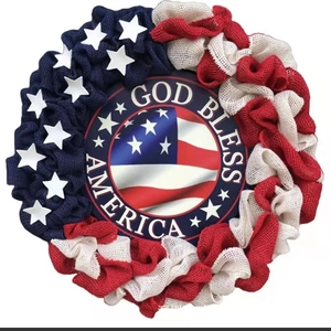 Close-up of burlap USA wreath with God Bless America sign and rustic texture